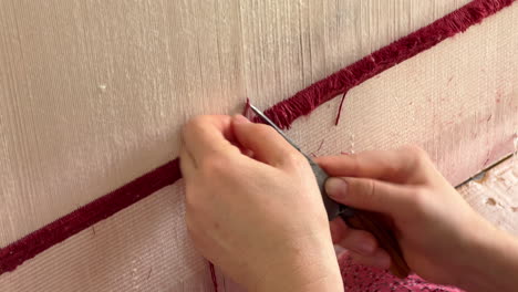 Woman-hands-weaving-carpet-in-Uzbekistan