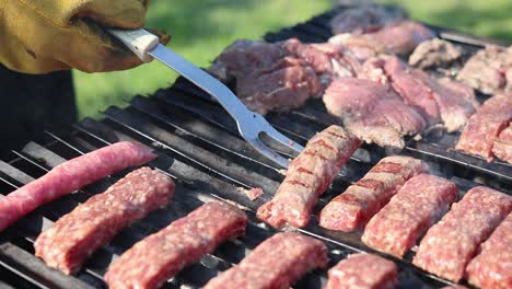 Grilling-Rolled-Minced-Pork-Outdoor-During-Sunny-Day,-Close-up-Shot