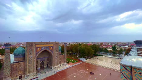 Aerial-cityscape-The-Registan-Square-is-the-best-place-to-discover-the-old-Uzbek-architecture-and-to-enjoy-the-great-mosaic-decorations,-Samarkand,-Uzbekistan