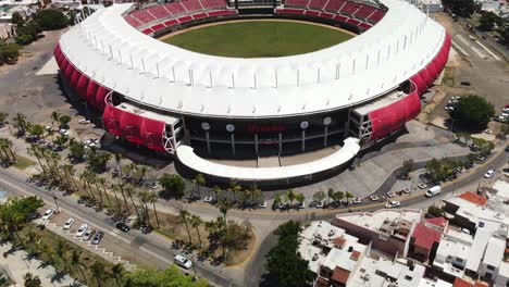 Mexico-city-street-traffic-aerial-view-tilt-up-to-inside-colourful-circular-baseball-stadium-ground