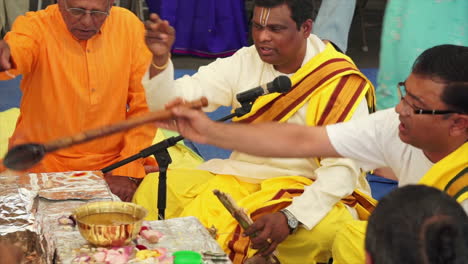Hindu-priest-spoons-a-religious-offering-of-ghee-onto-a-ritual-fire