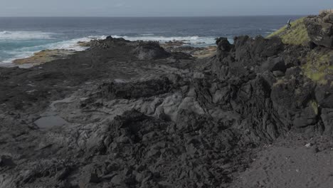 Rugged-coastal-landscape-of-Mosteiros,-Azores,-Sao-Miguel,-featuring-volcanic-rocks-and-distant-ocean-views