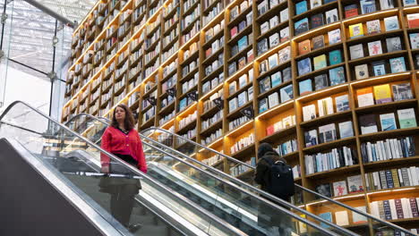 Woman-Riding-Escalator-On-Starfield-Library-Inside-Coex-Mall-In-Seoul,-South-Korea