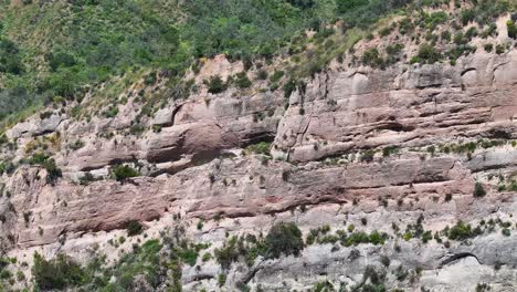 otherworldly-rock-formations-in-Trabuco-Canyon-Rancho-Santa-Margarita-California-mid-day-rock-spine-dynamic-shadows-AERIAL-TELEPHOTO-TRUCKING-PAN-60fps