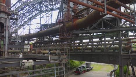 Tilt-down-shot-of-historic-abandoned-ironworks,-now-a-heritage-site-in-Volklingen,-Saarbrucken,-Germany-at-daytime