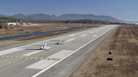 Aerial-View-of-Two-Propeller-Airplanes-on-the-Runway---Sunny-Day