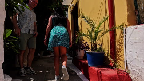 POV-shot-while-walking-along-the-street-of-Anafiotika,-Plaka-district,-Athens,-Greece-on-a-sunny-day