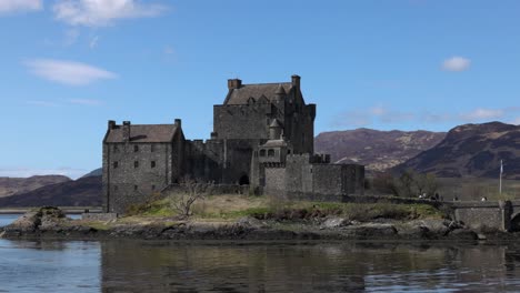 Hand-held-shot-of-tourists-exploring-the-exterior-of-Eilean-Donan-Castle