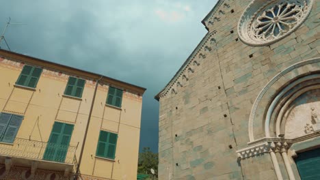 Cinque-Terre-Corniglia-Church-Facade,-Houses,-Balconies,-Clouds