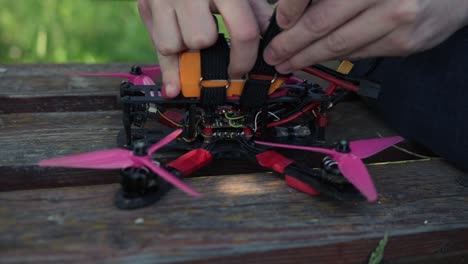 Hände-Schnallen-Die-Batterie-Einer-FPV-Drohne-Vor-Dem-Fliegen-Fest