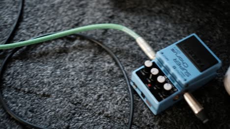 Slow-Motion-Shot-Of-Guitarist-Using-A-Chorus-Pedal