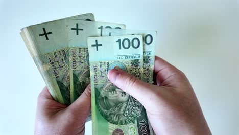 A-man-counts-cash,-Polish-currency,-PLN