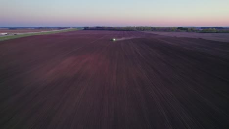 Aerial-View-of-Tractor-Plowing-a-Field-at-Dusk