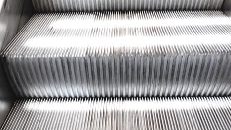 Riding-an-escalator-up-into-an-uncovered-shopping-mall-parking-lot,-Hawaii