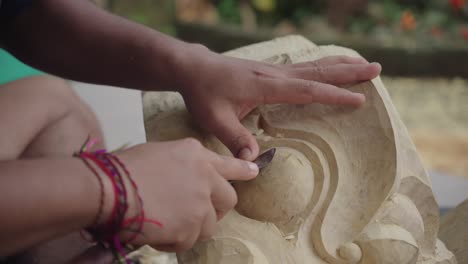 Hands-Of-A-Man-Making-Traditional-Wood-Carving-In-Bali,-Indonesia---Close-Up