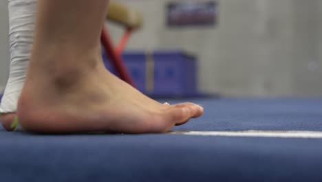 Spring-board-gymnastics-mat-and-feet-during-a-practice