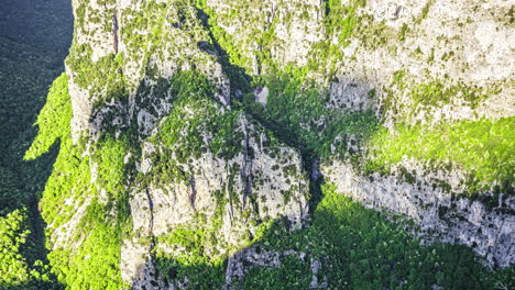 Looking-down-into-the-Vikos-Gorge,-Greece-as-clouds-pass-overhead---time-lapse-of-shadows-on-the-mountainside