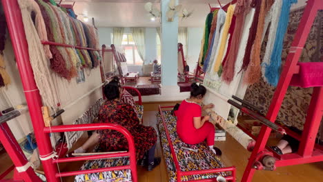 Two-young-ladies-weaving-a-handmade-carpet