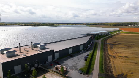 Massive-industrial-greenhouse-and-building-complex-in-Belgiium,-aerial-view