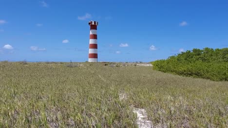 Dirt-road-towards-lighthouse,-cayo-de-agua-island-Los-Roques-Venezuela,-tilt-down