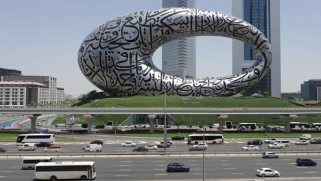 Dubai-traffic-on-Sheikh-Zayed-Road,-framed-by-the-Museum-of-the-Future-and-Emirates-Towers-in-the-background,-United-Arab-Emirates