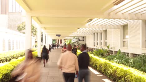 Timelapse-of-busy-pedestrian-business-people-man-and-woman-walking-in-and-out-of-Nairobi-University-in-Nairobi-City,-Kenya-East-Africa