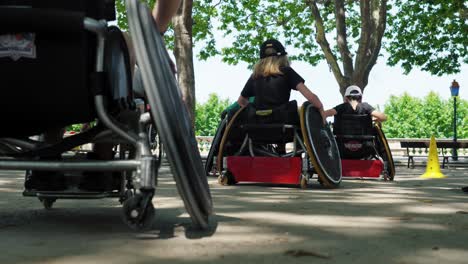 Slow-motion-shot-of-a-group-of-disabled-people-in-sports-wheelchairs