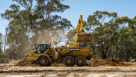 Time-lapse-of-an-excavator-filling-a-dump-truck-with-soil-at-a-housing-development-site