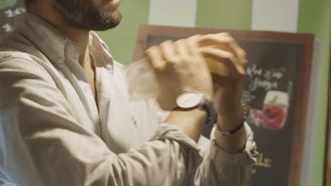 Barman-preparing-and-shaking-a-caipirinha