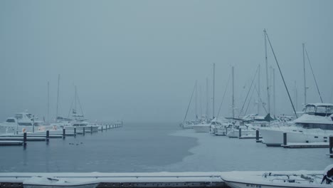 An-early-winter-morning-on-the-Poulsbo-Harbor-during-a-rare-Seattle-snow-storm,-looking-out-at-the-boats