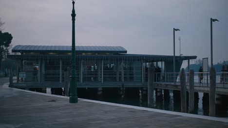 Modern-ferry-terminal-with-green-lamppost-at-dusk-on-Burano-Island,-Venice