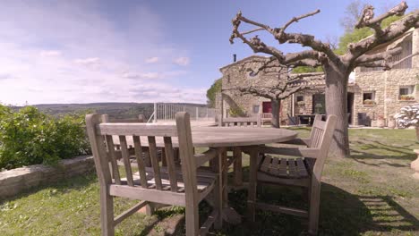 Slow-establishing-shot-of-garden-furniture-sitting-outside-a-villa-in-France