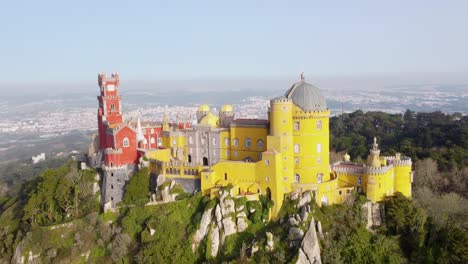 Stunning-View-of-the-Colorful-Pena-Palace-in-Sintra,-Portugal:-Aerial-"Dolly-Zoom"-Shot-of-Sunlit-Castle-Near-Lisbon-on-a-Bright-Sunny-Day---European-Travel-Destination-and-UNESCO-World-Heritage-Site
