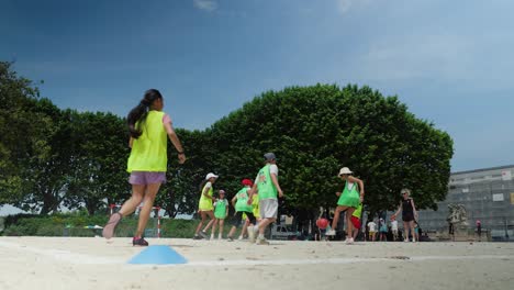 Slow-motion-low-angle-shot-of-children-playing-rounders-in-a-park