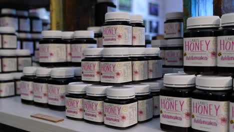 Close-up-of-large-jars-of-Honey-stacked-on-a-table-in-a-store-in-New-Zealand