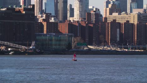 Camera-view-from-brooklyn-across-east-river-with-midtown-and-buoy-in-view