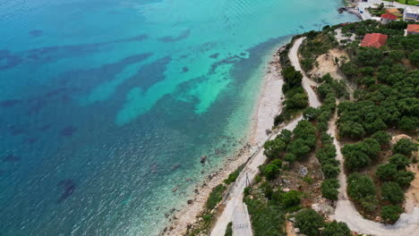 Aerial-Panoramic-Drone-fly-turquoise-sea-white-sand-forested-beach-Greece-Travel-spot-resort