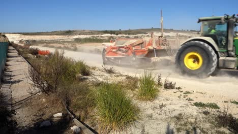 John-Deere-Traktor-Schleppt-Erdbewegungsmaschinen-Auf-Einer-Baustelle-In-Spanien