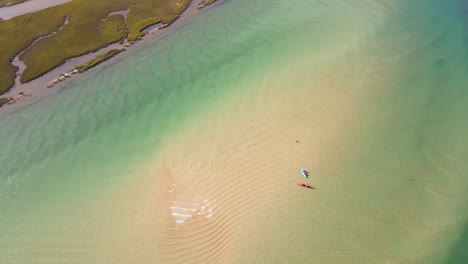 Kayakers-explore-sand-bank-in-clear-picturesque-Goukou-estuary,-Stilbaai