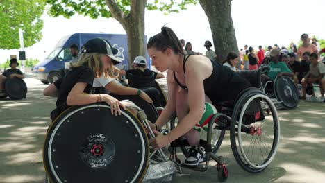 Slow-motion-shot-of-a-disabled-athlete-teaching-kids-wheelchair-volleyball