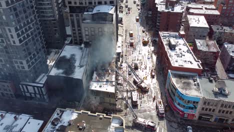 Teamwork-of-firefighters-on-ladder-truck-extinguishing-skyscraper-fire