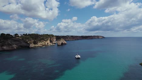 Sailboat-Anchored-Off-Shore-of-Cala-Llombards-Beach-in-Mallorca,-Spain