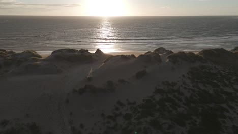 Aerial-view-of-sand-dunes-and-ocean-at-Ofir-Beach-in-Esposende,-Portugal-during-sunset