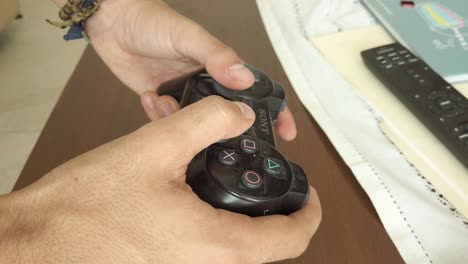 Close-up-of-hands-using-a-play-station-controller