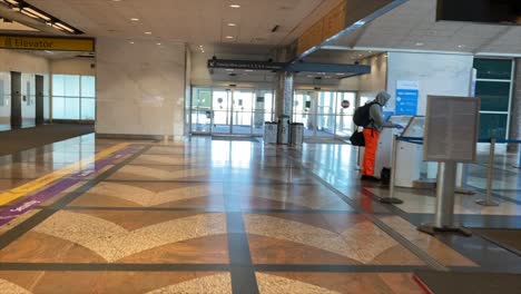 Man-Checking-In-For-Flight-In-Empty-Denver-Airport-During-COVID19-Pandemic