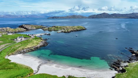 Drone-flying-over-secluded-beach,white-sands,turquoise-seas-and-sheltered-little-fishing-harbour,the-beauty-of-the-Beara-peninsula-West-Cork-Ireland-,peace-and-quiet-in-a-stunning-landscape