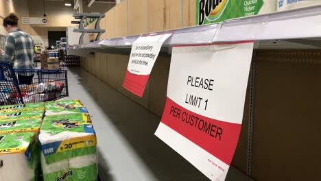 A-static-view-of-empty-paper-towel-shelves-in-a-grocery-store