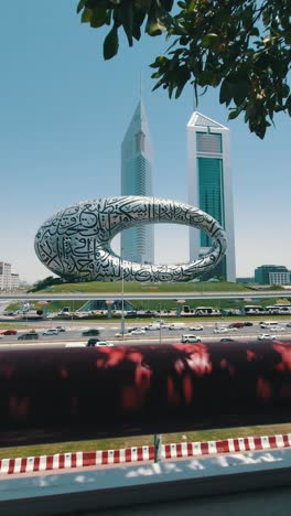 A-stunning-view-of-Dubai's-Museum-of-the-Future,-along-with-Sheikh-Zayed-Road-and-city-traffic