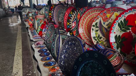 Various-ceramic-products-with-central-asian-folk-ornaments-on-the-counter-of-an-oriental-market