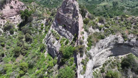 otherworldly-rock-formations-in-Trabuco-Canyon-Rancho-Santa-Margarita-California-mid-day-rock-spine-dynamic-shadows-AERIAL-PULLBACK-TILT-UP-60fps